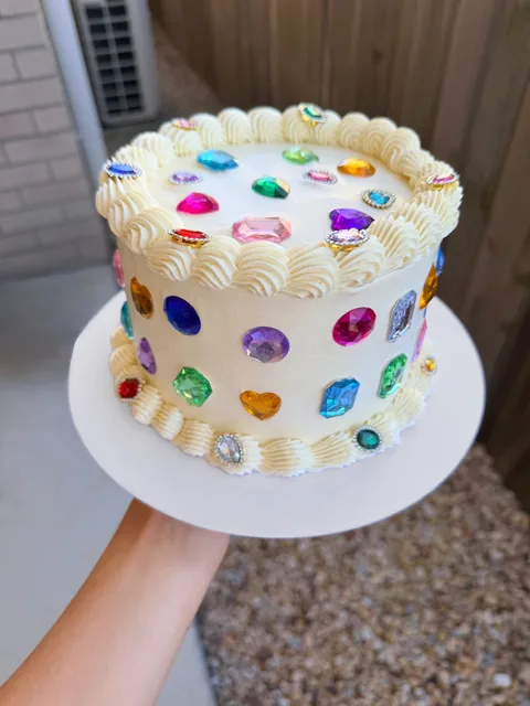 Cream vintage piped cake decorated with colourful sugar jewels